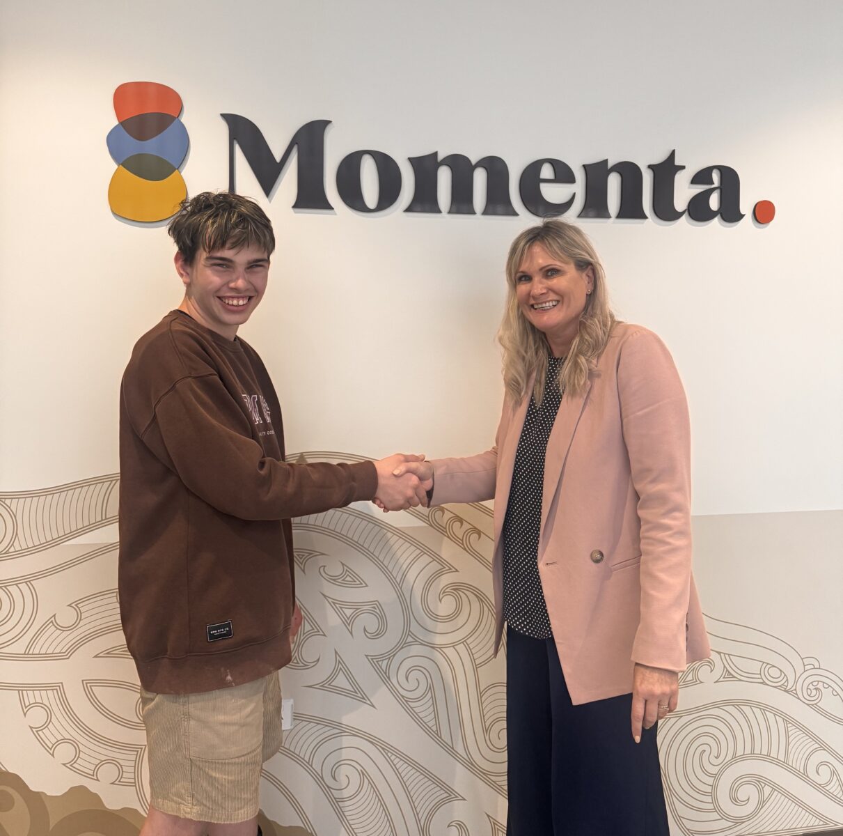 Momenta Chief Executive shakes Koen McKenzie's hand to congratulate him for winning the award.